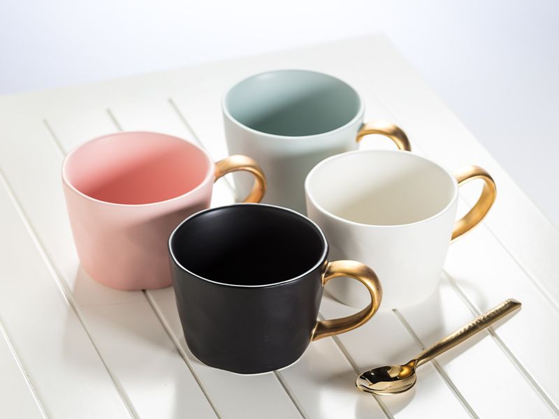 Colourful mugs with gold accent