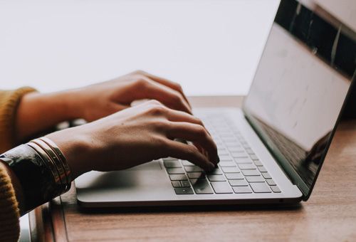 Person typing at computer