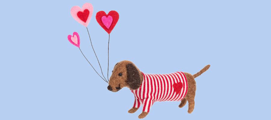 Fuzzy dog holding hearts