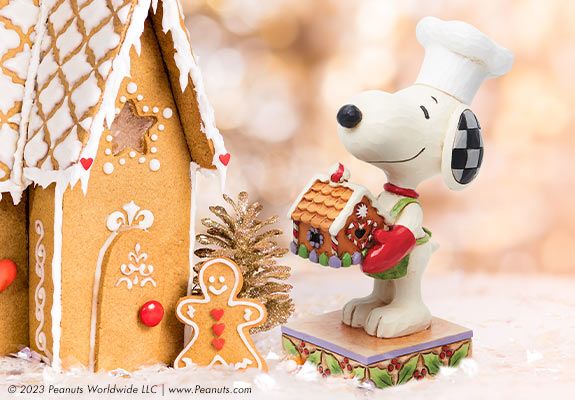 snoopy figurine with gingerbread house