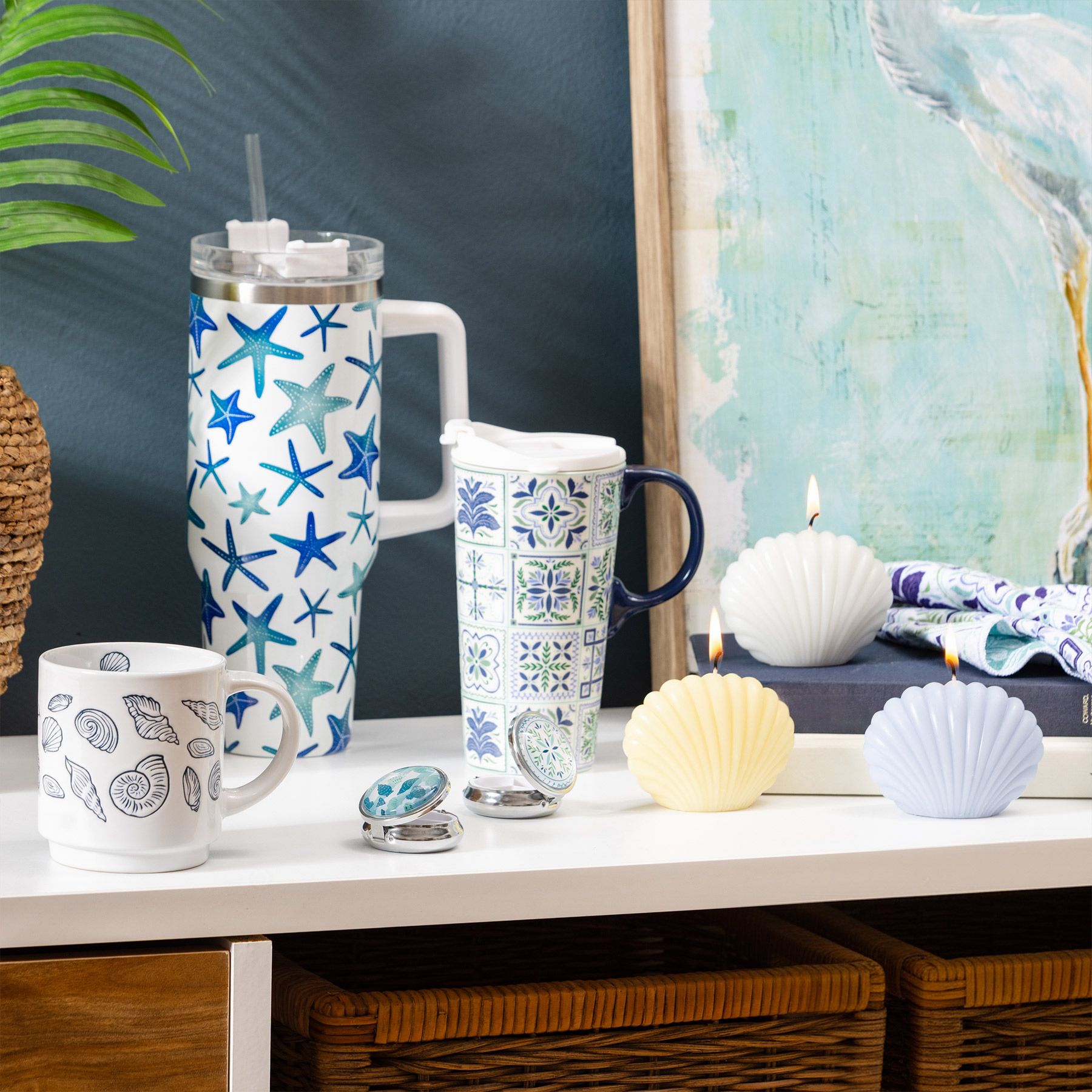 Seaside Retreat collection with starfish-print tumbler, Mediterranean tile travel mug, seashell candles, shell mug, and coastal artwork