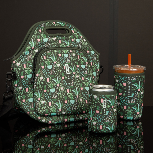 A coordinated green patterned insulated lunch bag, can cooler, and tumbler with a straw from Sok-It, displayed on a glossy black background.