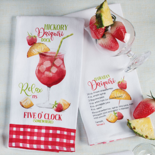 Two white kitchen towels decorated with a daiquiri drink graphic, tropical fruits, playful text, and a cocktail recipe, styled with fresh fruit and a cocktail glass.