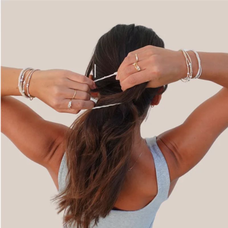 Gypsea Bands girl putting hair band in hair